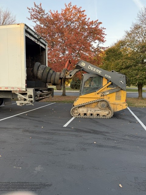 Loader lifting tires into a truck