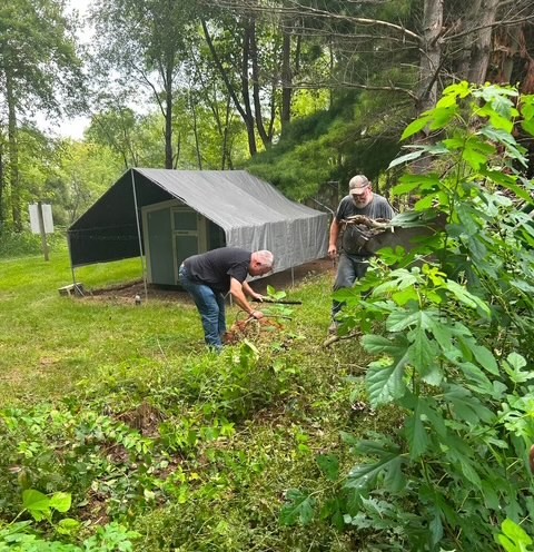 Volunteers clearing brush and working outdoors